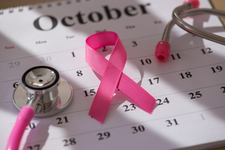 An breast cancer awareness October calendar with a pink bow on it