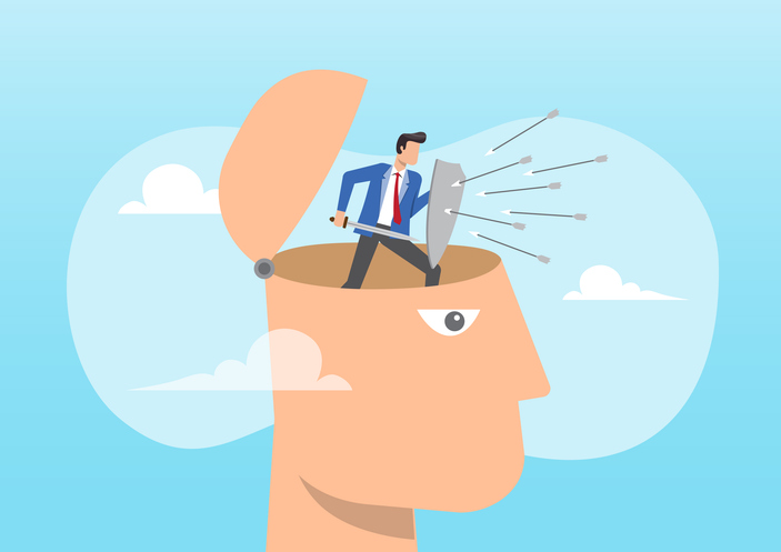 Cartoon of a man inside a brain using a shield to block arrows, representing protection from cognitive biases in charitable giving.
