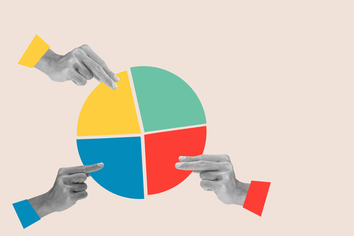 Hands holding a multicolored pie chart representing charity expense allocation.