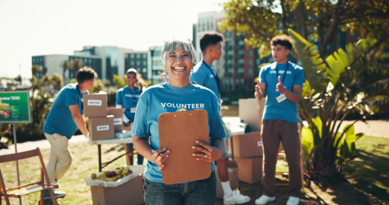 Volunteer team organizing boxes, showing how volunteering supports local communities