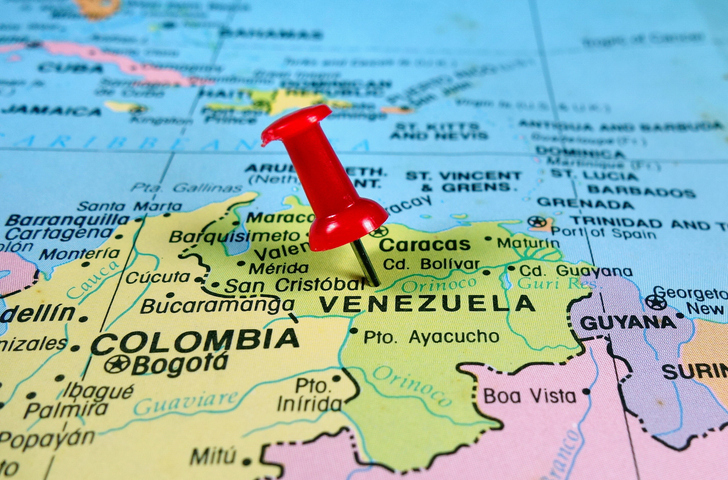 pushpin marking Venezuela on a map