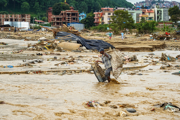 People gathering belongings in a flood-affected area in Nepal